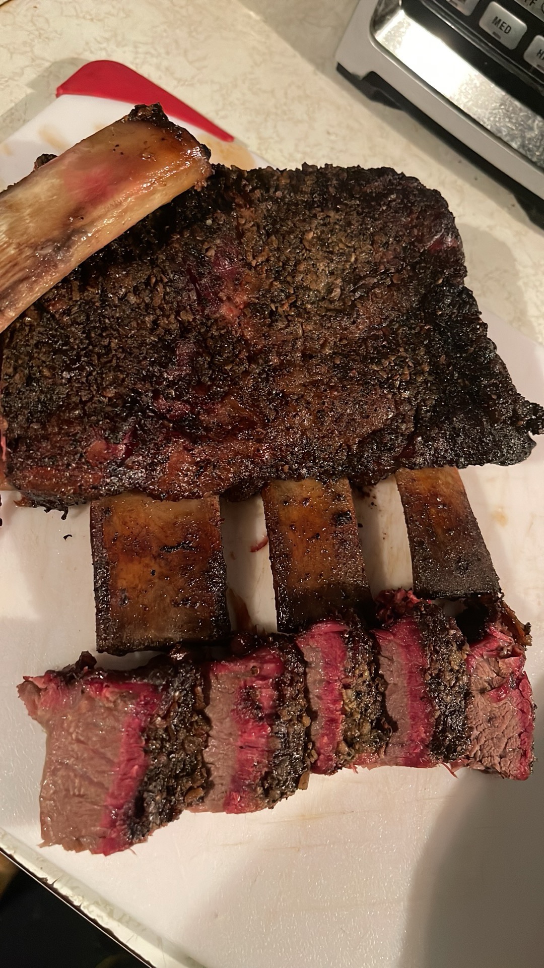 Smoked beef short ribs with peppery bark and a deep smoke ring
