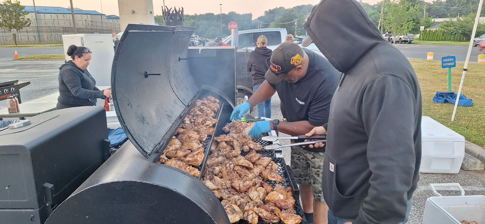Big D cooking BBQ chicken at a community event